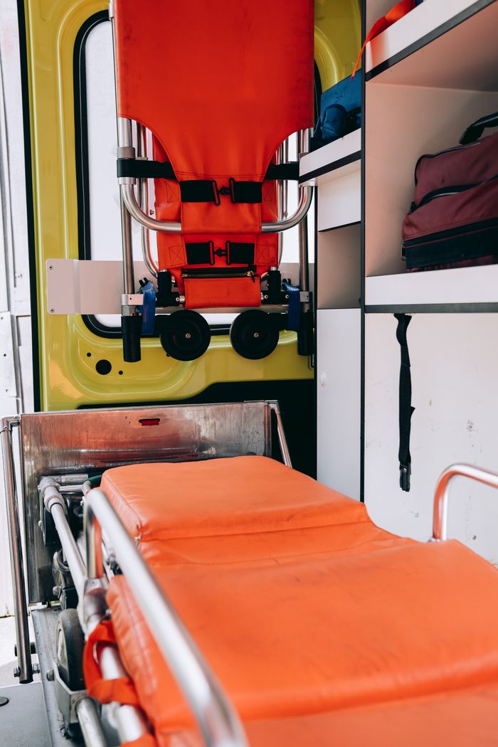 Interior view of a modern ambulance showcasing a stretcher and essential medical equipment for emergencies.